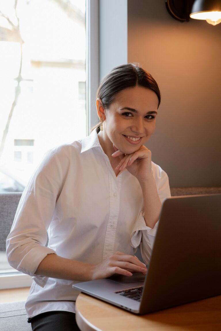 Confident woman working on laptop with positive mindset, success focus, and wealth affirmation energy