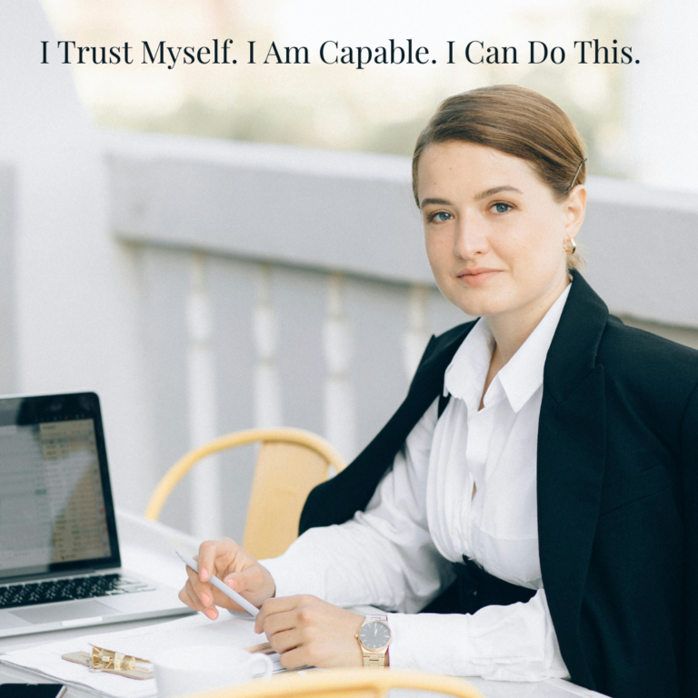 confident woman working on laptop showing self belief and confidence mindset