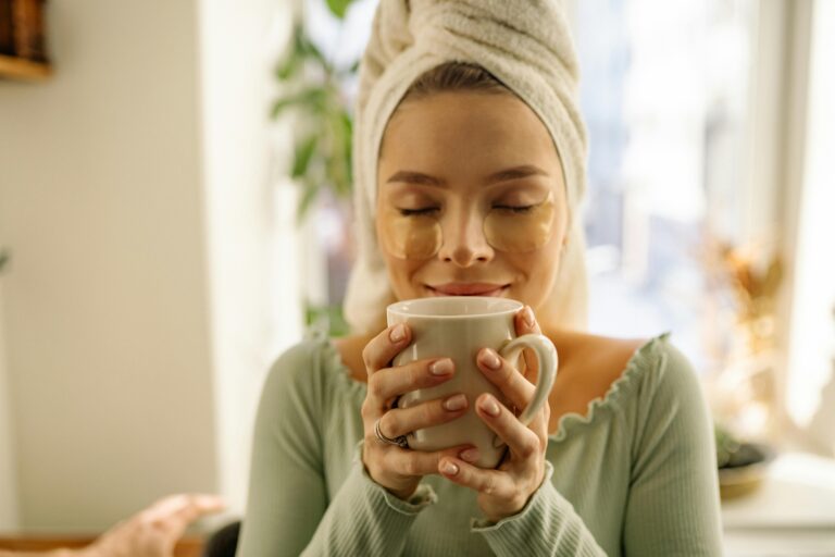 Calm woman holding a coffee cup in a peaceful home while practicing daily self-love affirmations for inner strength