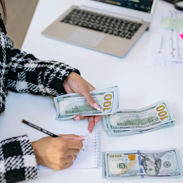 person planning finances and counting money for wealth and abundance mindset